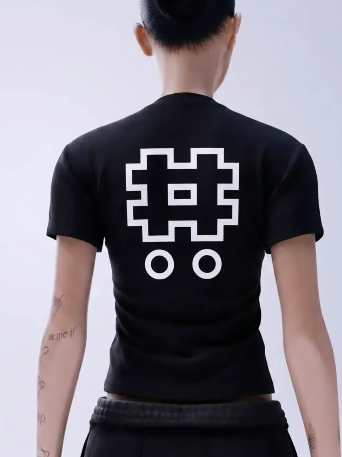 Back of the black Night Dweller Baby Tee with the Classofinfinitty mark printed large in white